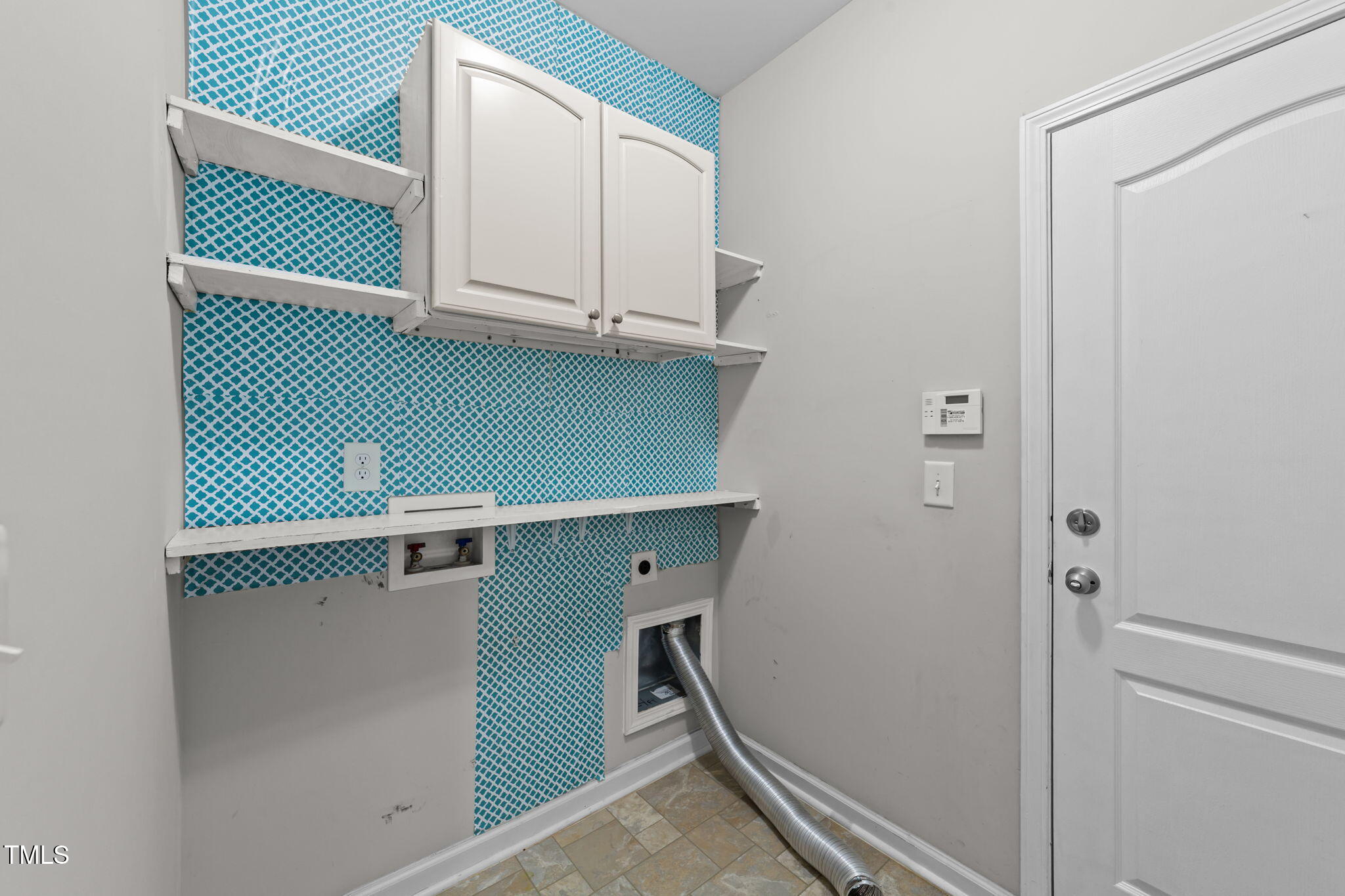 83 Mariners Point Way Garner, NC 27529 - Photo 29 of 49 a view of cabinets and utility room