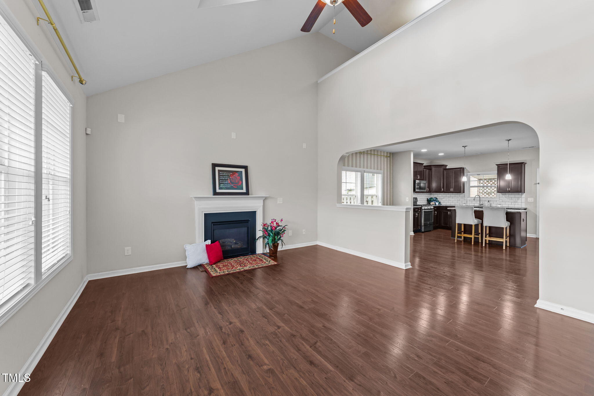 83 Mariners Point Way Garner, NC 27529 - Photo 3 of 49 an empty room with wooden floor fire place and windows