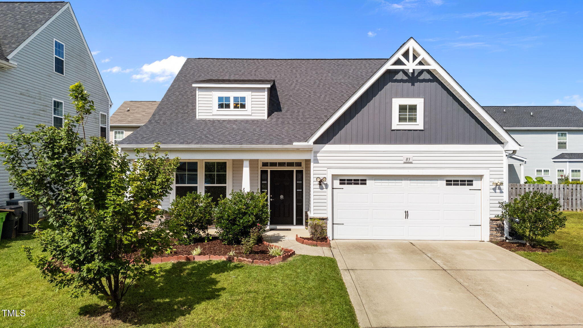 83 Mariners Point Way Garner, NC 27529 - Photo 31 of 49 a front view of a house with a yard and garage
