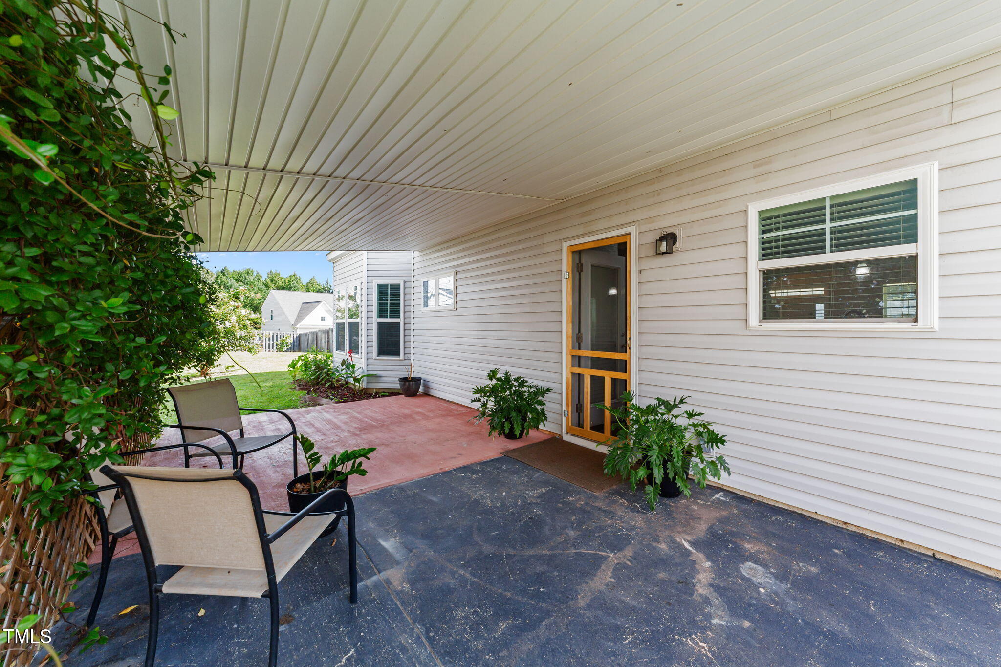 83 Mariners Point Way Garner, NC 27529 - Photo 4 of 49 a view of a patio with table and chairs and potted plants