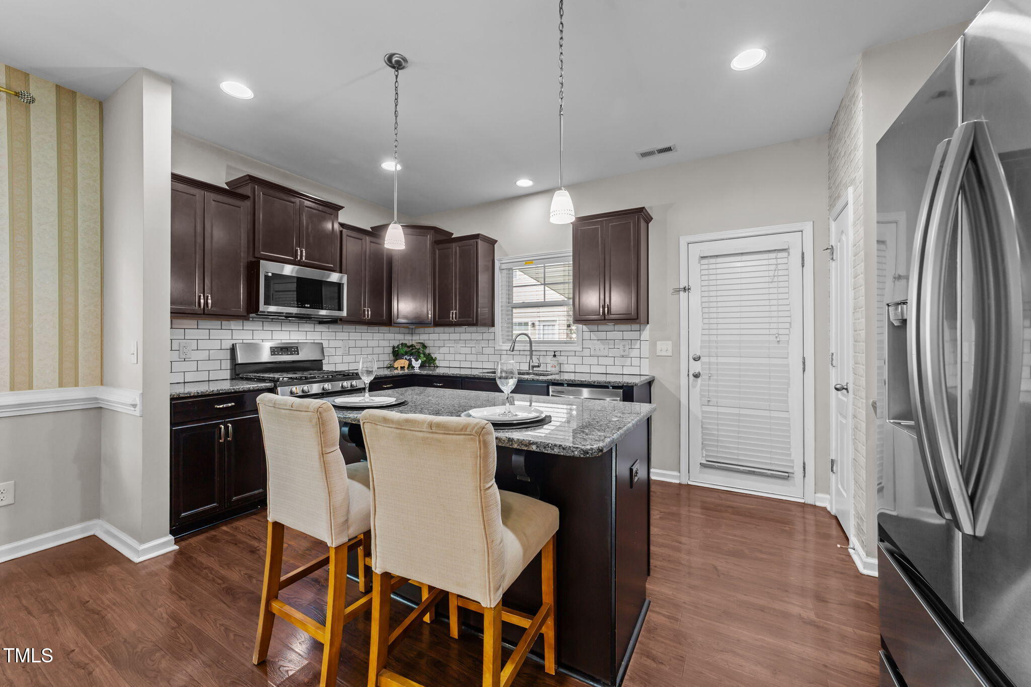 83 Mariners Point Way Garner, NC 27529 - Photo 7 of 49 a kitchen with stainless steel appliances granite countertop a refrigerator a stove a sink a microwave and a refrigerator