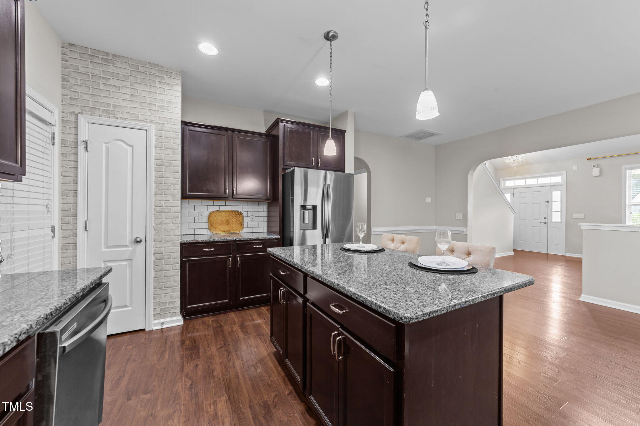 83 Mariners Point Way Garner, NC 27529 - Photo 8 of 49 a kitchen with stainless steel appliances granite countertop a sink a stove and a wooden floors