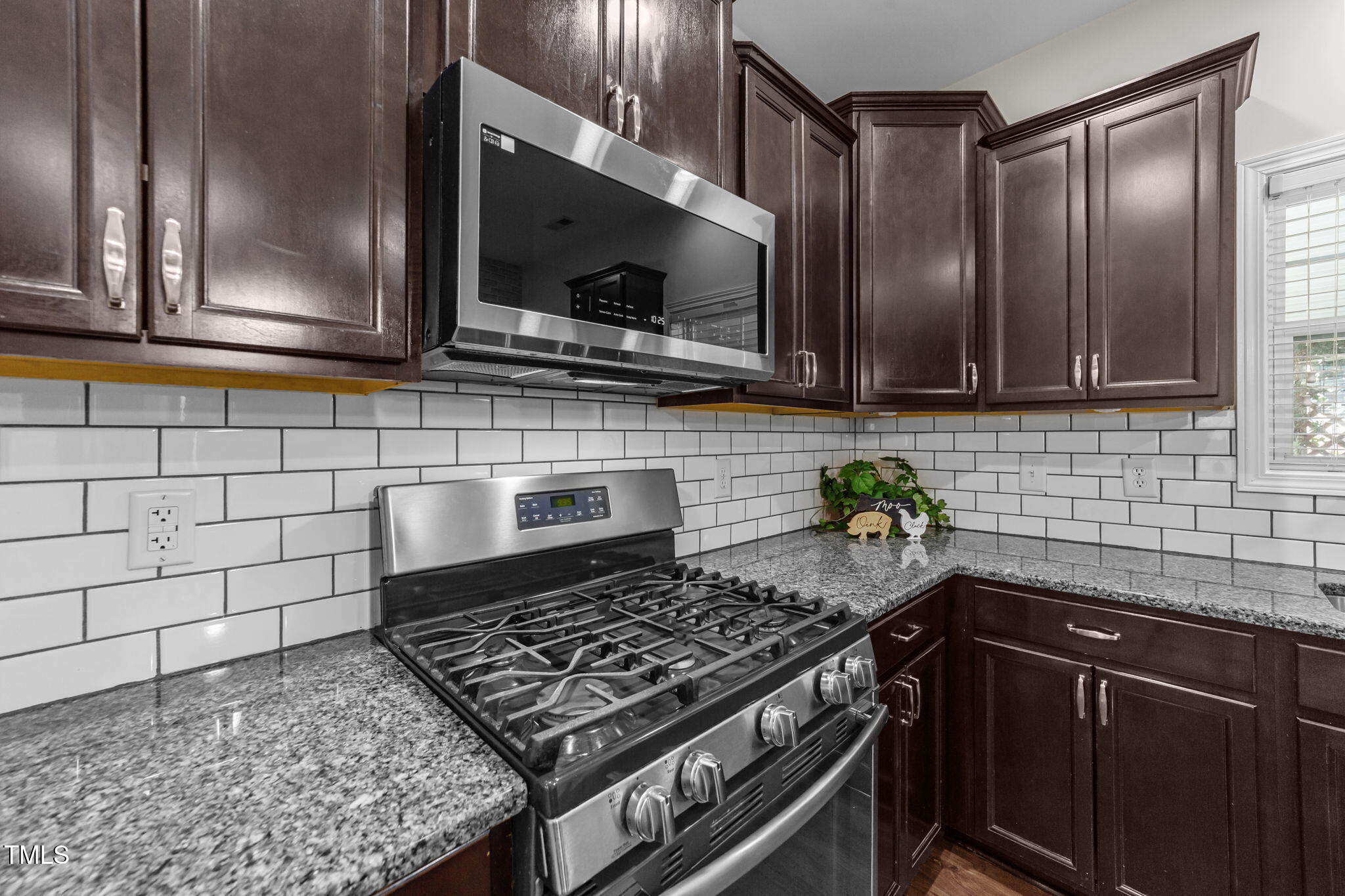 83 Mariners Point Way Garner, NC 27529 - Photo 9 of 49 a kitchen with stainless steel appliances a sink dishwasher a stove a microwave and cabinets