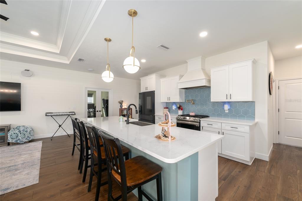 6659 Southwest 12th Lane Gainesville, FL 32607 - Photo 12 of 37 a kitchen with a dining table chairs sink and cabinets