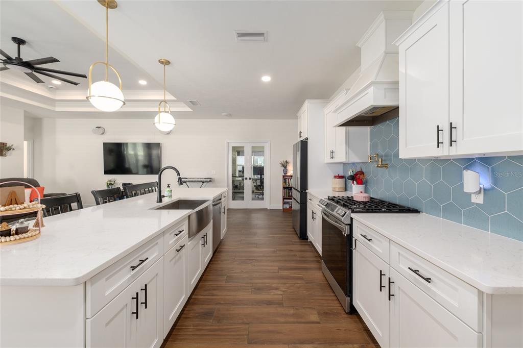 6659 Southwest 12th Lane Gainesville, FL 32607 - Photo 13 of 37 a large kitchen with stainless steel appliances and white cabinets