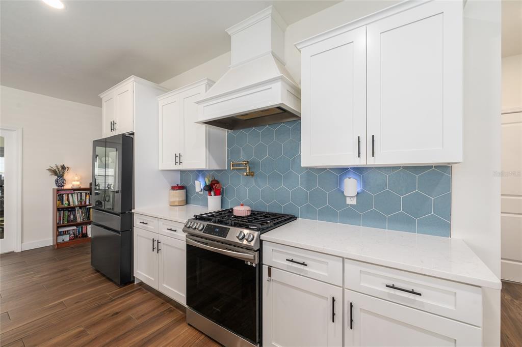 6659 Southwest 12th Lane Gainesville, FL 32607 - Photo 15 of 37 a kitchen with white cabinets and appliances