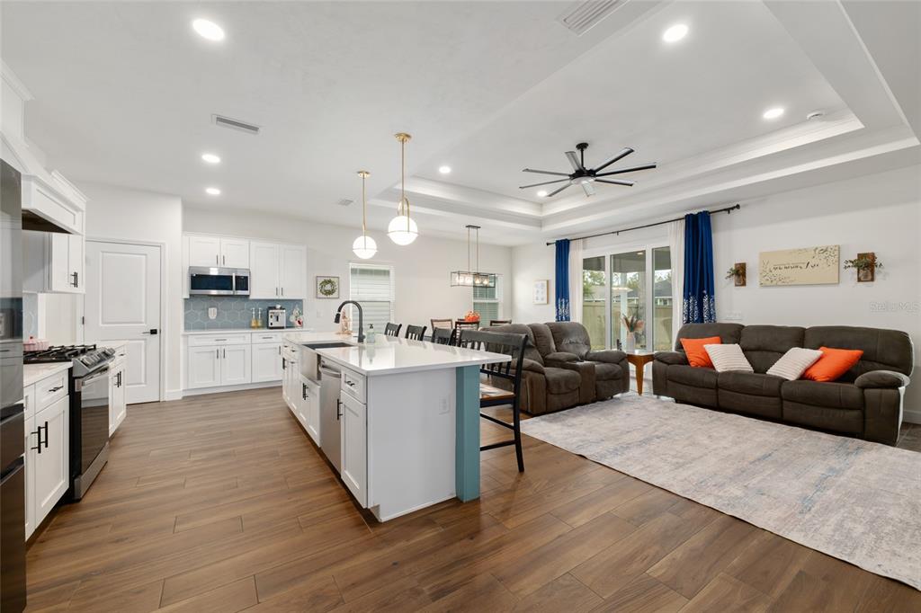 6659 Southwest 12th Lane Gainesville, FL 32607 - Photo 16 of 37 a living room with stainless steel appliances kitchen island furniture and a kitchen view