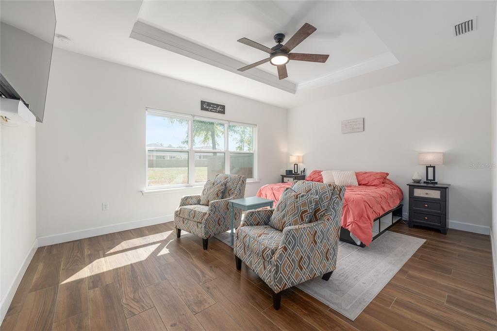 6659 Southwest 12th Lane Gainesville, FL 32607 - Photo 18 of 37 a spacious bedroom with a bed couch and window