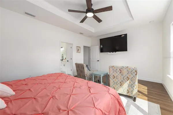 a bedroom with a bed window and a flat screen tv