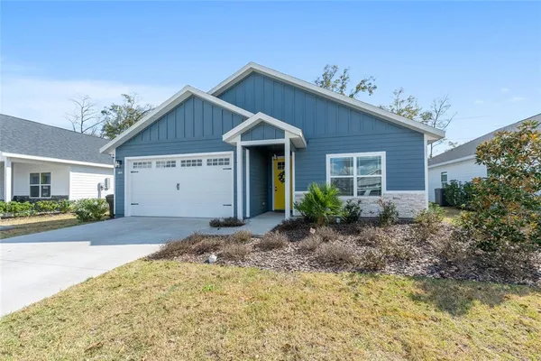 a view of a house with a yard and garage