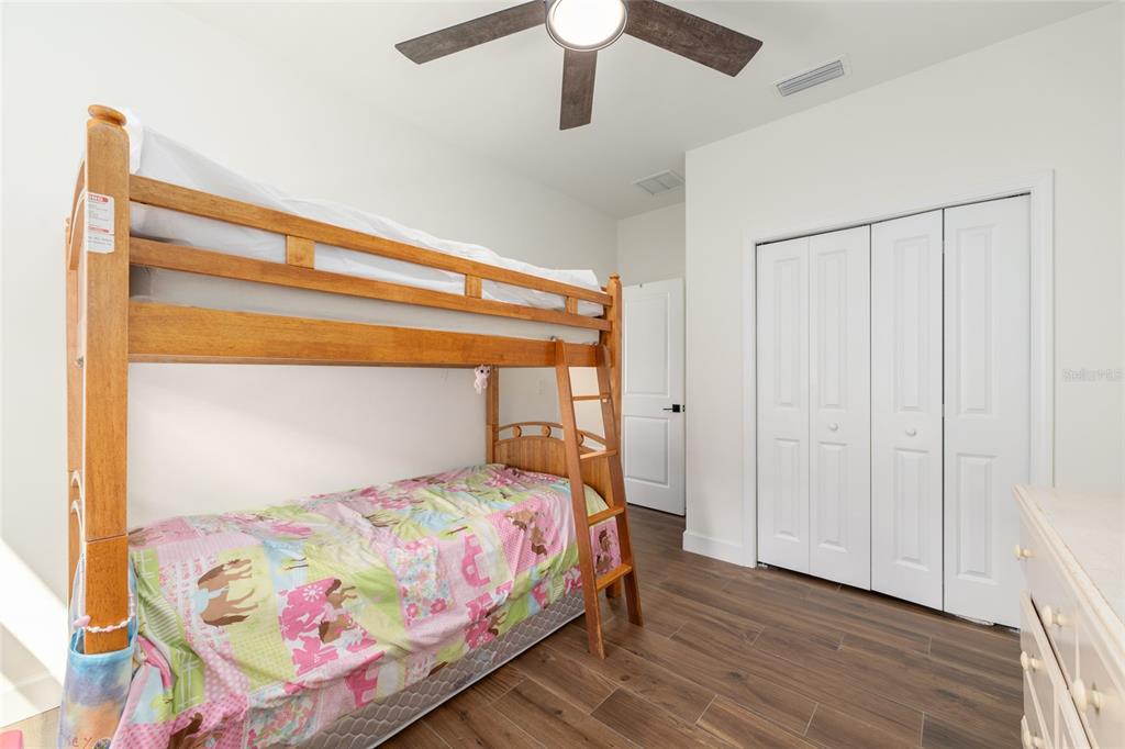 6659 Southwest 12th Lane Gainesville, FL 32607 - Photo 24 of 37 a bedroom with a bed and a chandelier