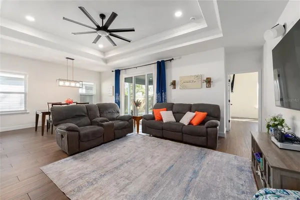 a living room with furniture ceiling fan and a rug