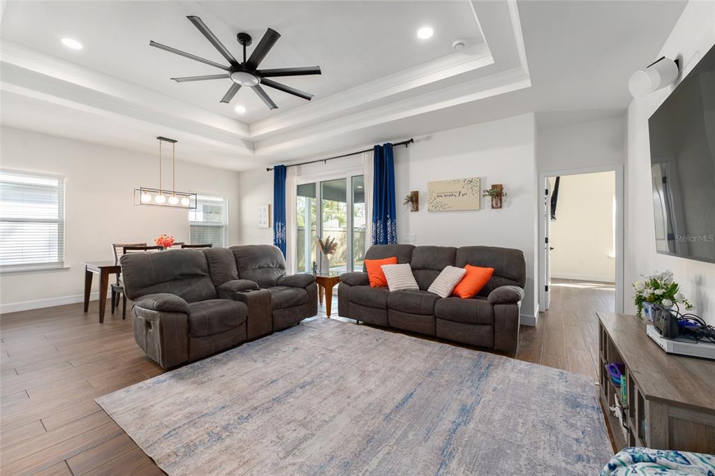 6659 Southwest 12th Lane Gainesville, FL 32607 - Photo 4 of 37 a living room with furniture ceiling fan and a rug