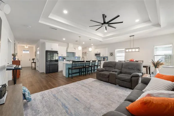 a living room with furniture and kitchen view