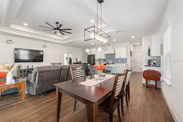 a view of a dining area with furniture wooden floor and a chandelier