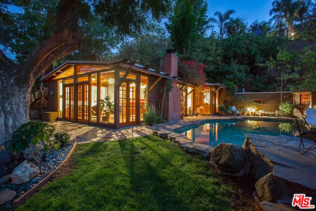 a view of swimming pool with a backyard