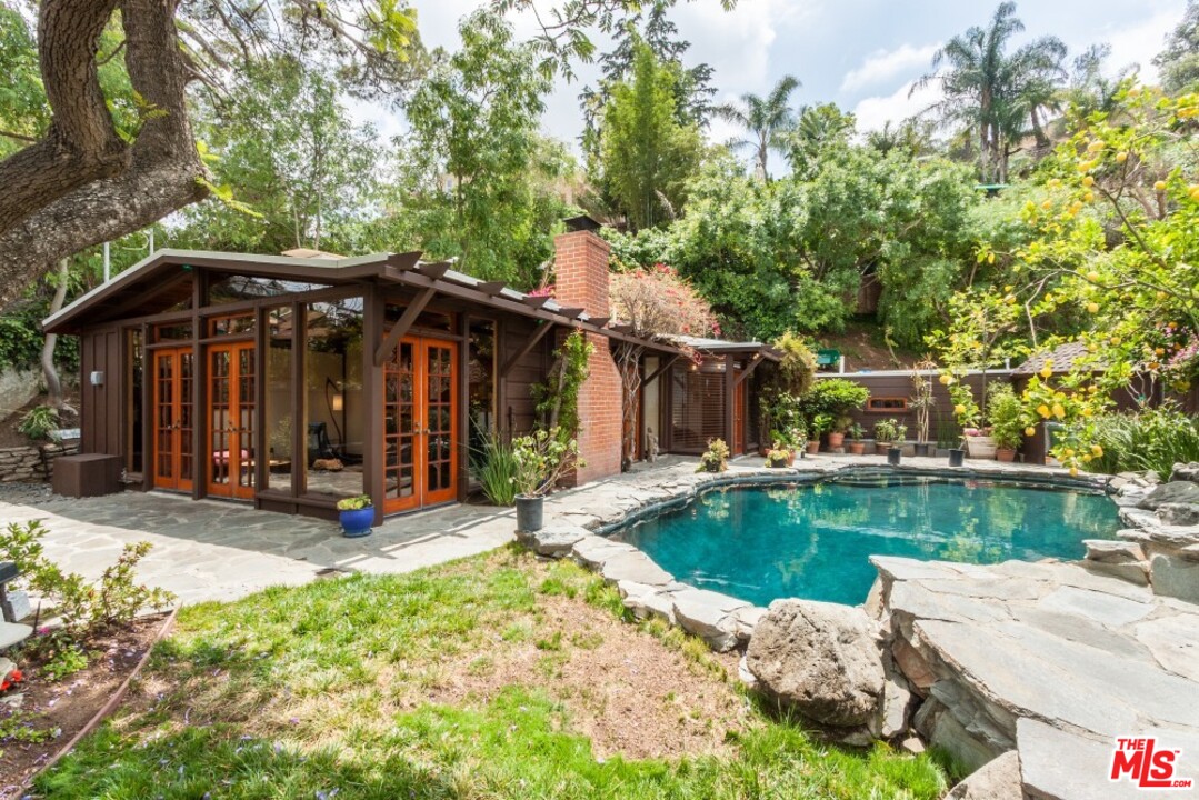7280 Caverna Drive Los Angeles, CA 90068 - Photo 2 of 30 a view of a house with backyard porch and sitting area