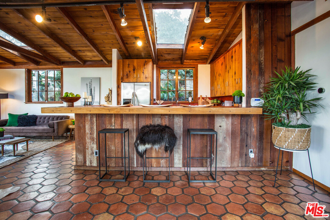 7280 Caverna Drive Los Angeles, CA 90068 - Photo 14 of 30 a living room with a table and chairs