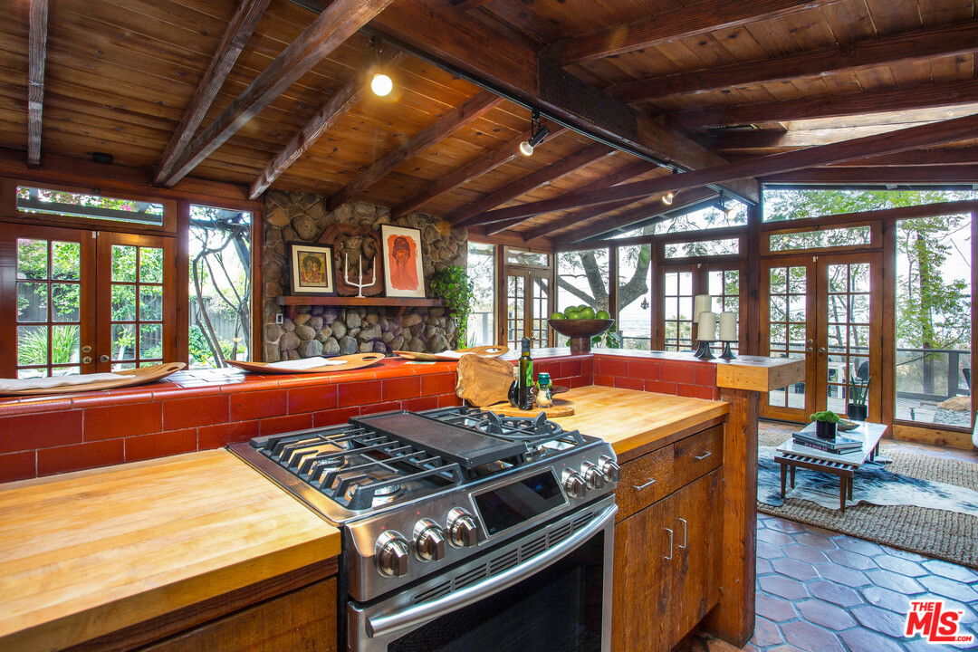 7280 Caverna Drive Los Angeles, CA 90068 - Photo 16 of 30 a kitchen with a stove and a wooden floors