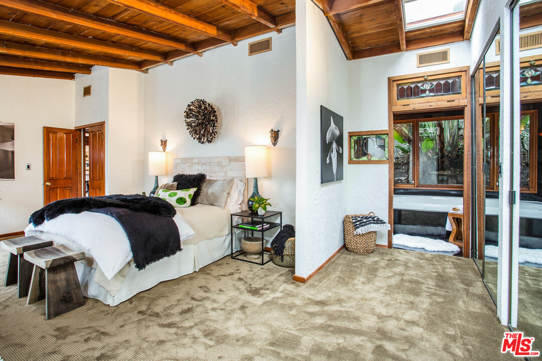 7280 Caverna Drive Los Angeles, CA 90068 - Photo 23 of 30 a bedroom with a bed and a table