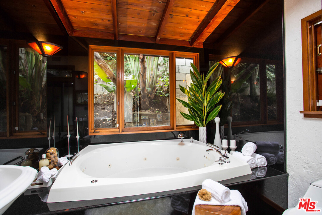 7280 Caverna Drive Los Angeles, CA 90068 - Photo 25 of 30 a bath tub sitting in a bathroom next to a window