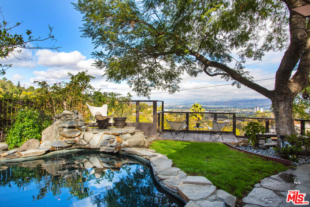 7280 Caverna Drive Los Angeles, CA 90068 - Photo 29 of 30 a view of a patio with table and chairs and potted plants