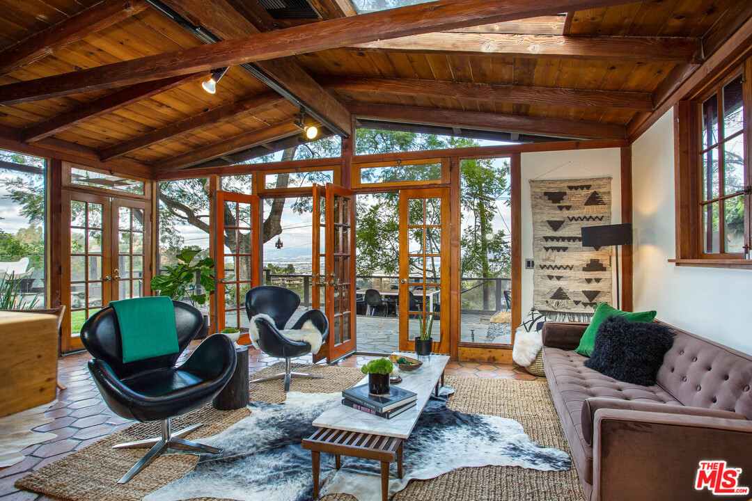 7280 Caverna Drive Los Angeles, CA 90068 - Photo 7 of 30 a living room with furniture a rug potted plant and a large window