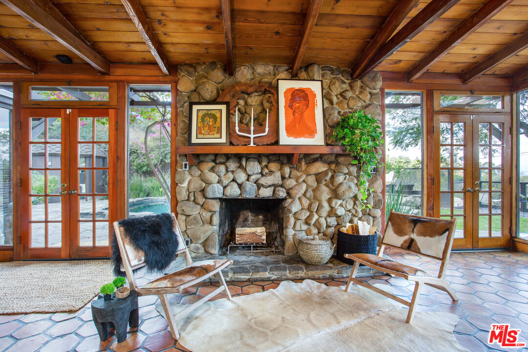 7280 Caverna Drive Los Angeles, CA 90068 - Photo 9 of 30 a living room with furniture windows and a fireplace