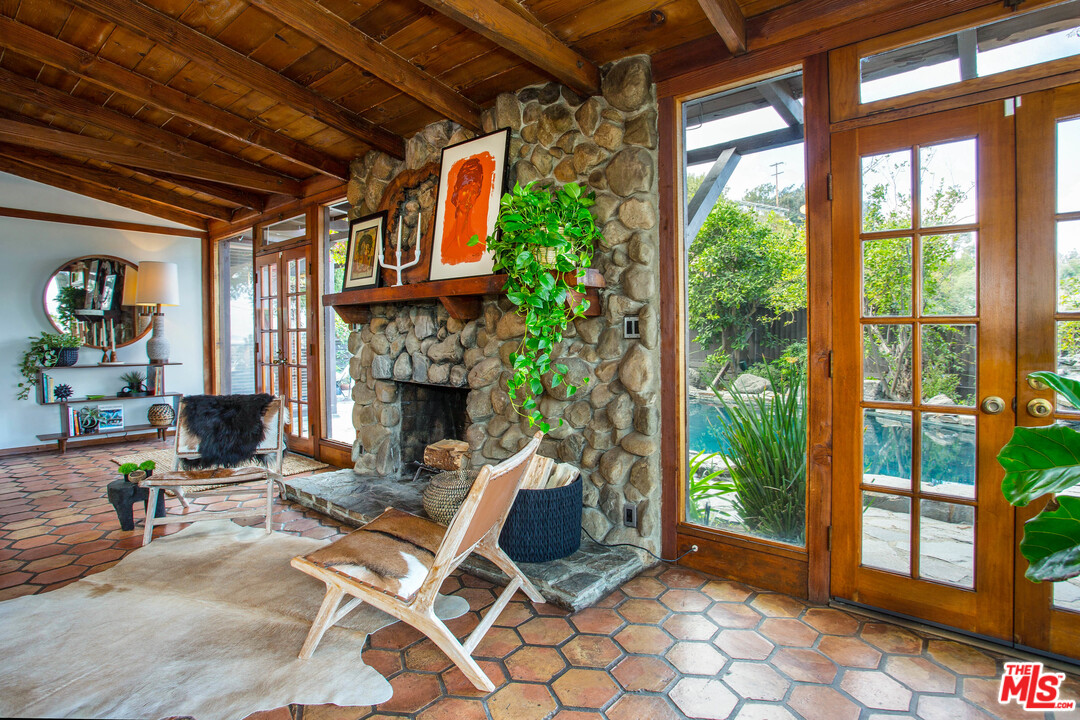 7280 Caverna Drive Los Angeles, CA 90068 - Photo 10 of 30 a living room with patio furniture and a fireplace