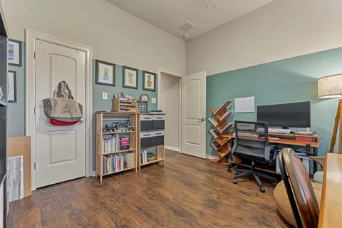 a view of a workspace with furniture and wooden floor