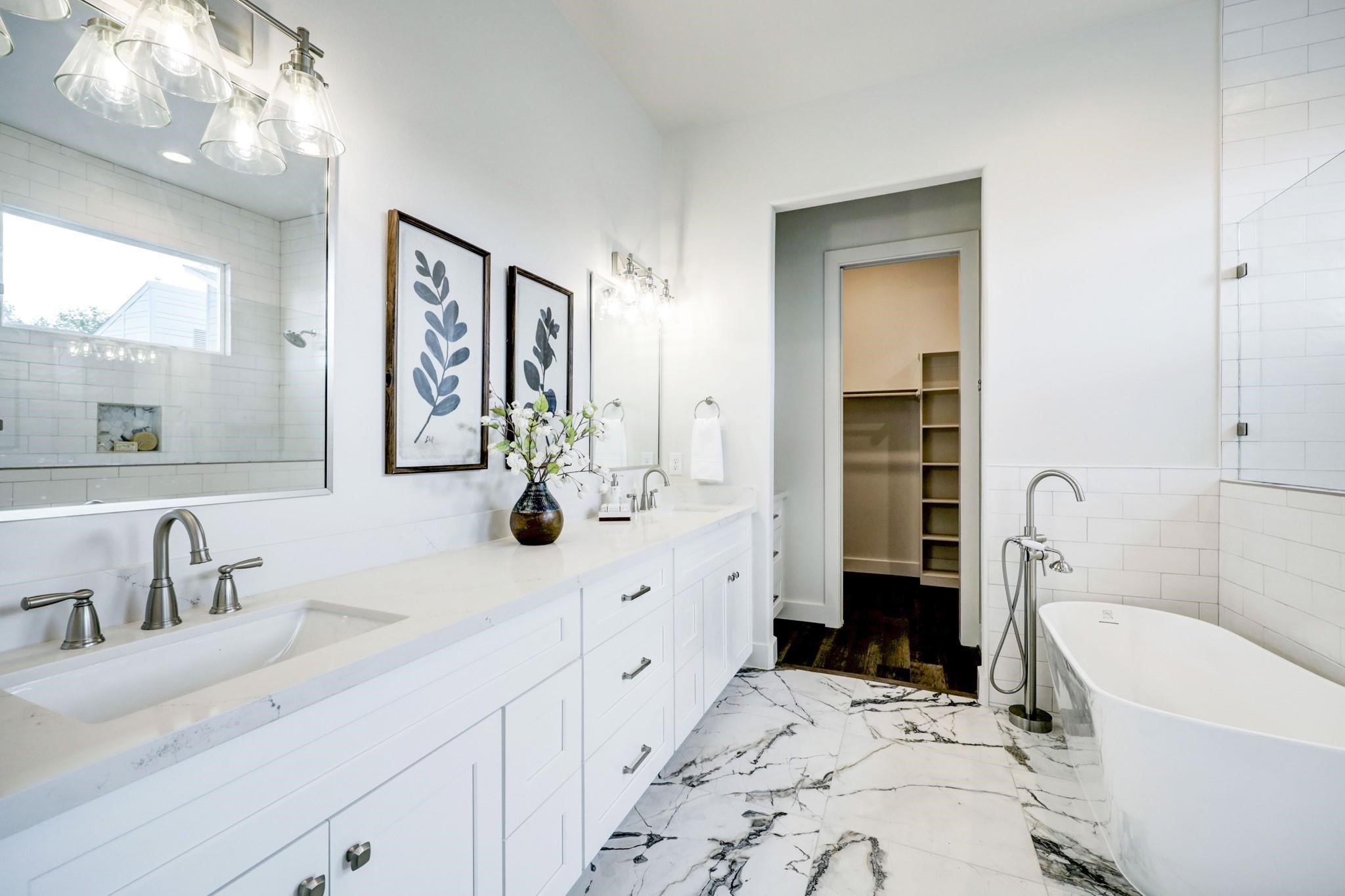 3827 Arlington Street Houston, TX 77018 - Photo 21 of 39 Bathroom features a double vanity with sleek fixtures, a freestanding tub, and elegant flooring. The space is bright with ample natural light and has a walk-in closet for convenience.