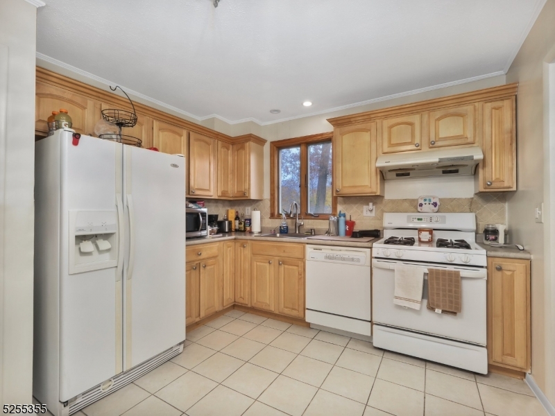 69 Intervale Road Boonton, NJ 07005 - Photo 12 of 29 a kitchen with white cabinets and white appliances