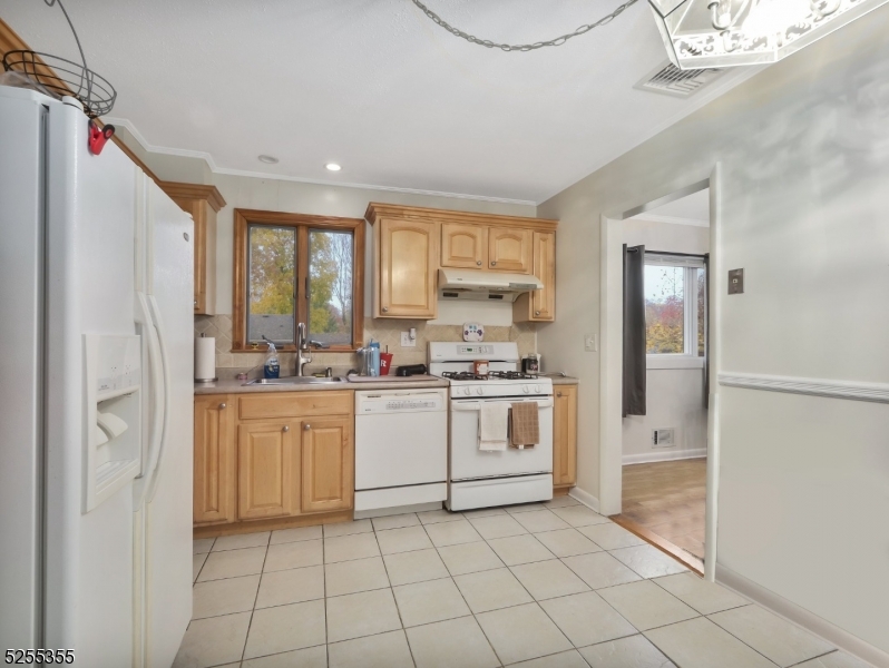 69 Intervale Road Boonton, NJ 07005 - Photo 13 of 29 a kitchen with white cabinets and white appliances