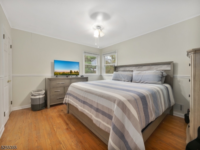 69 Intervale Road Boonton, NJ 07005 - Photo 16 of 29 a spacious bedroom with a bed and a chandelier