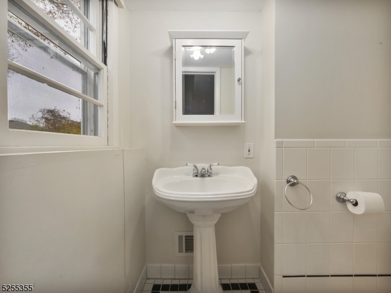 69 Intervale Road Boonton, NJ 07005 - Photo 20 of 29 a bathroom with a sink and a mirror