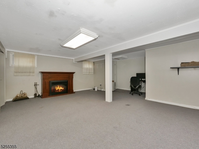 69 Intervale Road Boonton, NJ 07005 - Photo 21 of 29 an empty room with furniture and a fireplace