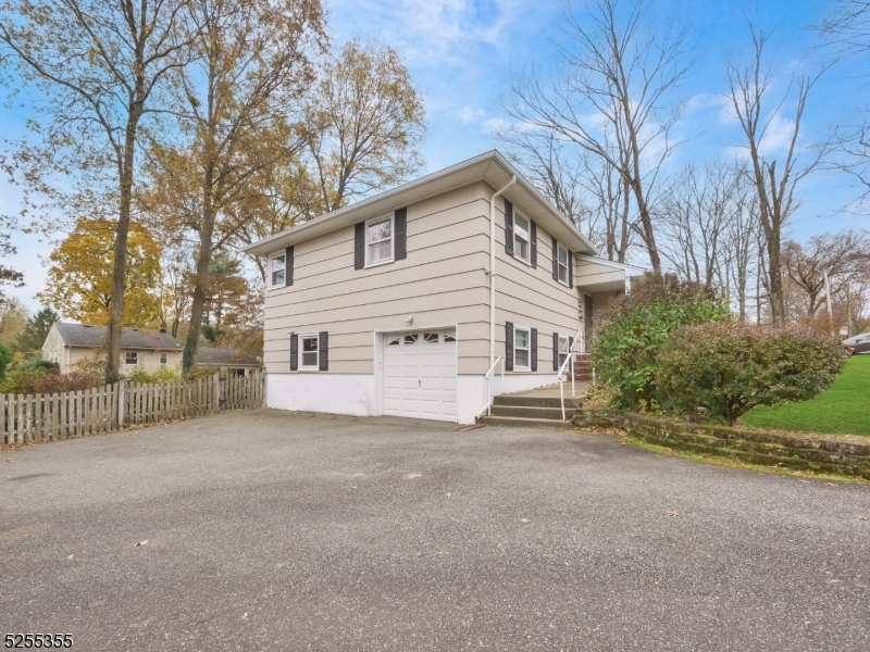 69 Intervale Road Boonton, NJ 07005 - Photo 25 of 29 a view of a house with a big yard and large trees