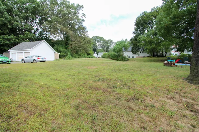 a view of backyard with small garden and entertaining space