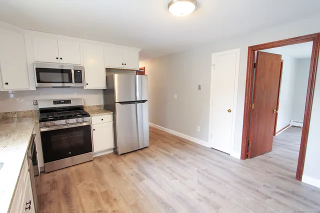 a kitchen with stainless steel appliances a refrigerator stove and microwave