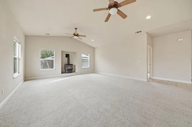 a view of a livingroom with a ceiling fan and window