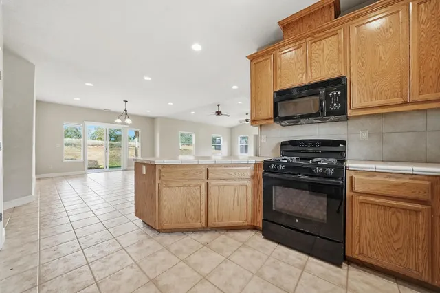 a kitchen with stainless steel appliances granite countertop a sink and cabinets