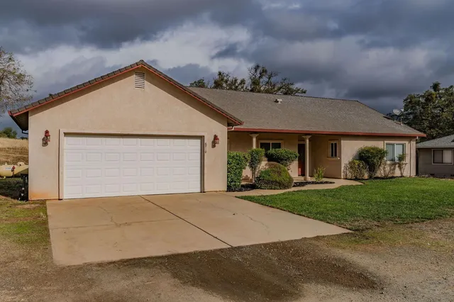 a front view of a house with a yard and garage