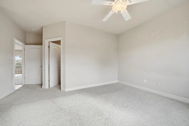 a bathroom with a granite countertop sink mirror and toilet