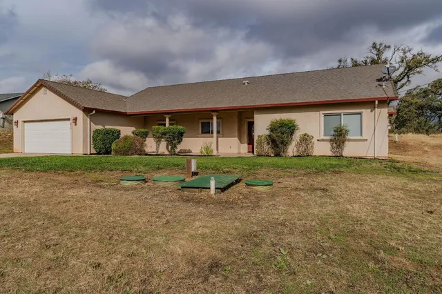 a backyard of a house with lots of green space