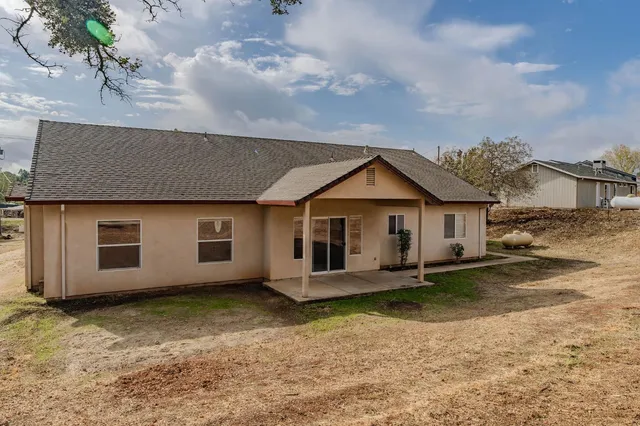 a view of a yard with yellow lighting