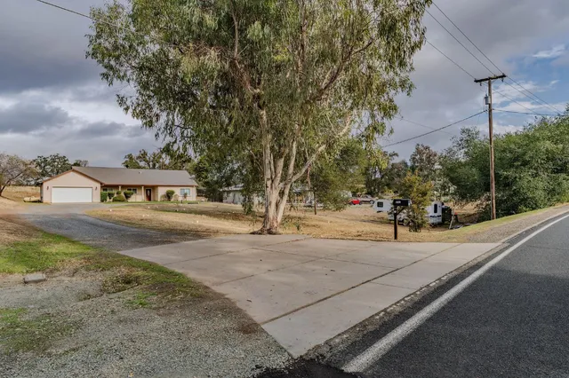 a view of a street with houses in back