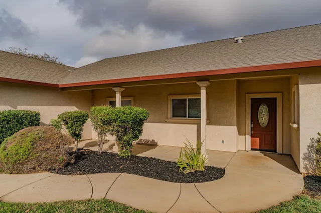 a front view of a house with garden