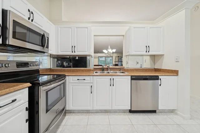 a kitchen with cabinets and steel stainless steel appliances