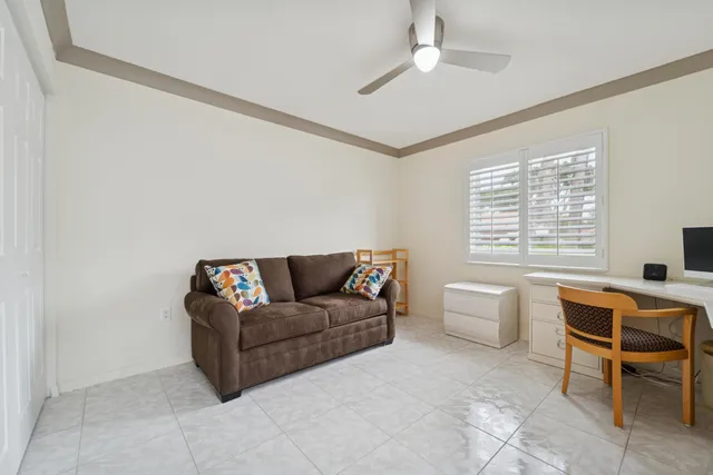 a view of a livingroom with workspace and a window