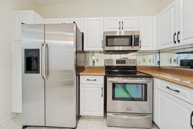 a kitchen with stainless steel appliances a stove microwave and refrigerator
